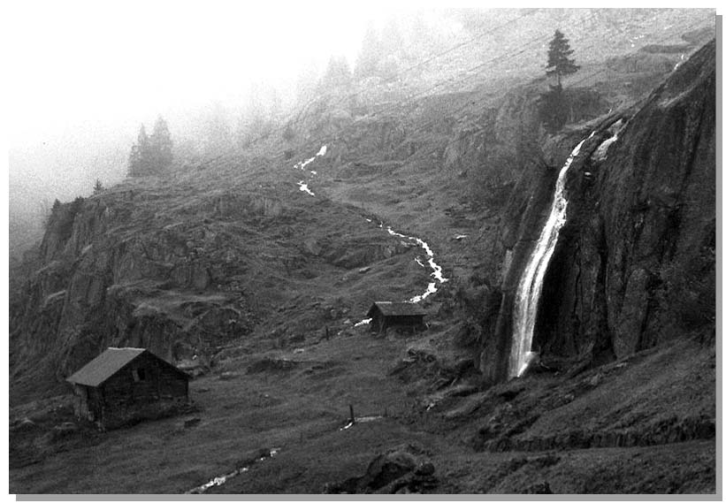 Old Wooden Barn with Waterfall—the Alps